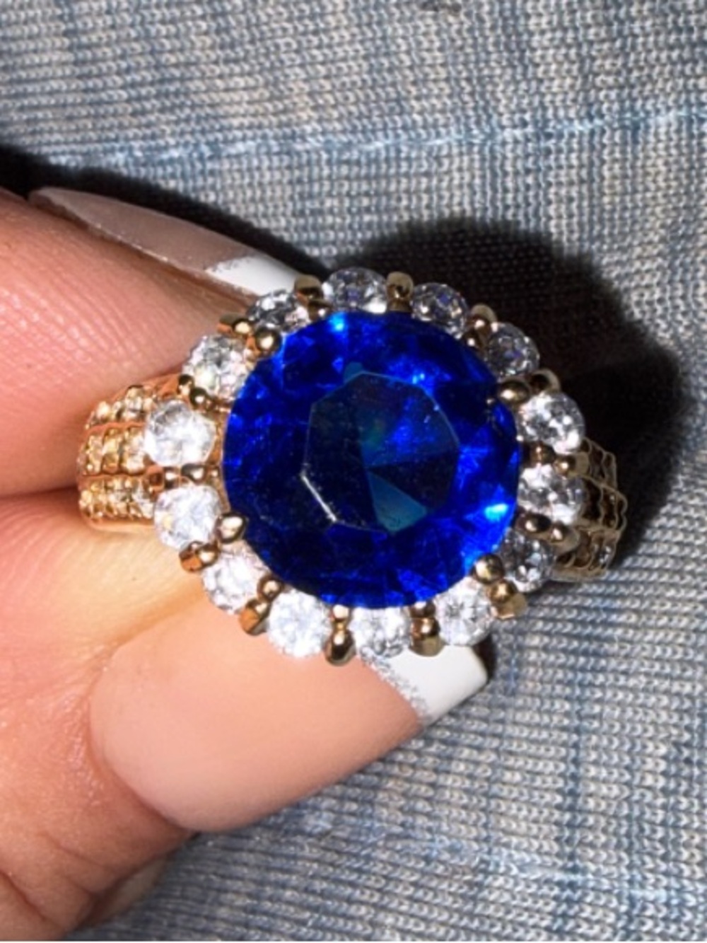 Gold Ring with Deep Blue Center Stone and Halo Accent